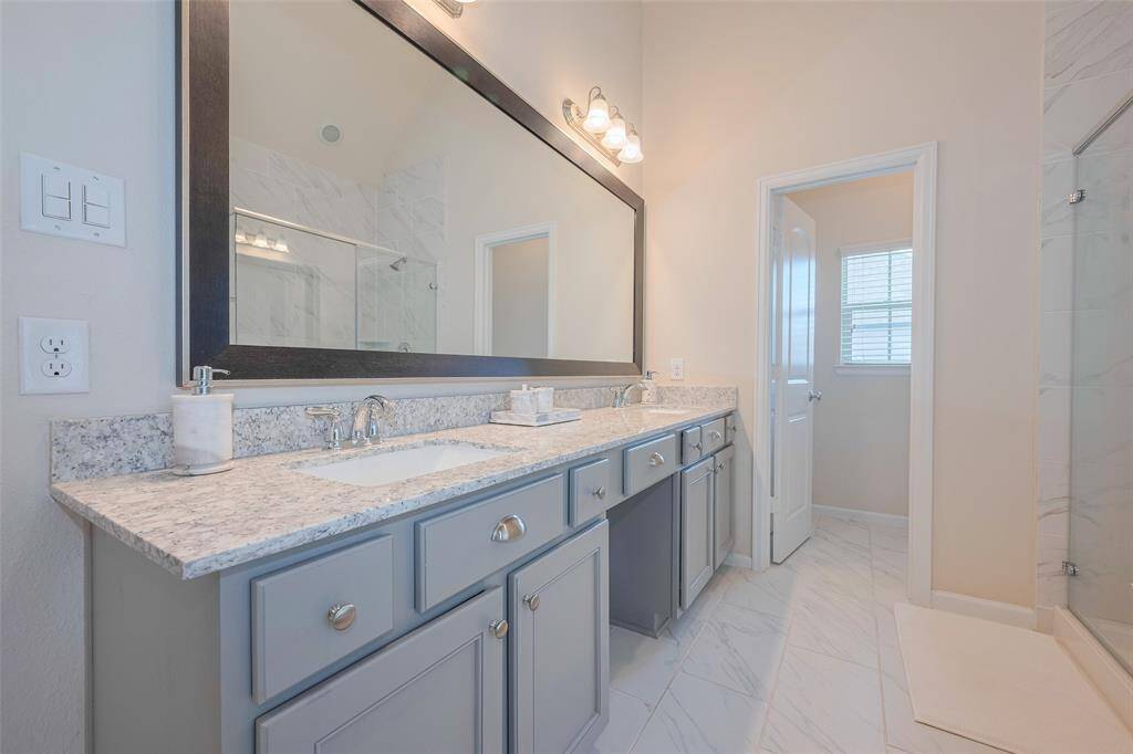 Primary bathroom includes double sinks and a vanity space