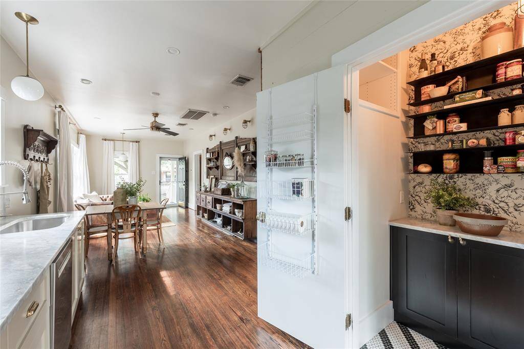 Tucked between the refrigerator and back door, the walk-in pantry closet offers discreet, functional storage while keeping essentials close at hand.