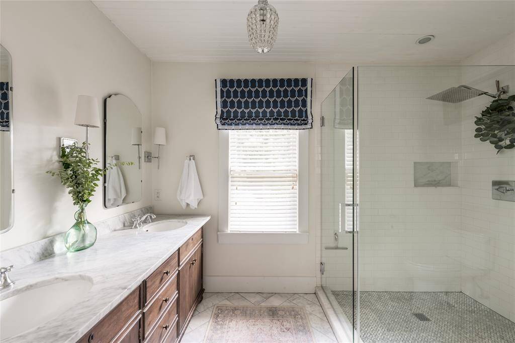 An oversized frameless glass shower and contemporary finishes create a serene, elevated space built for daily indulgence.