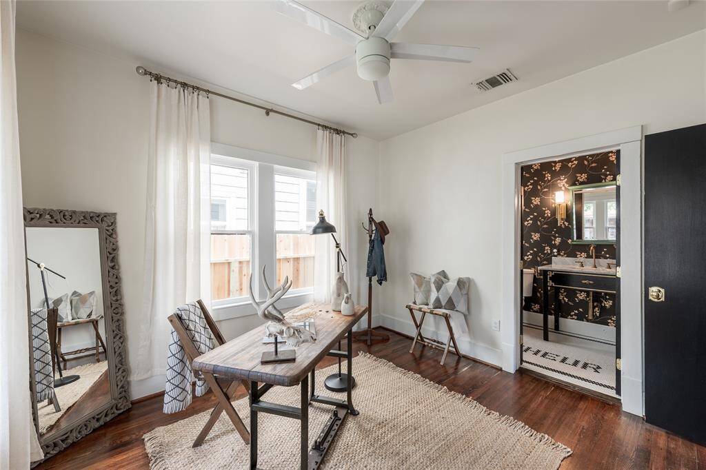 Located at the front of the home, this bright and versatile room is currently staged as an office but easily flexes as a guest suite or nursery.
