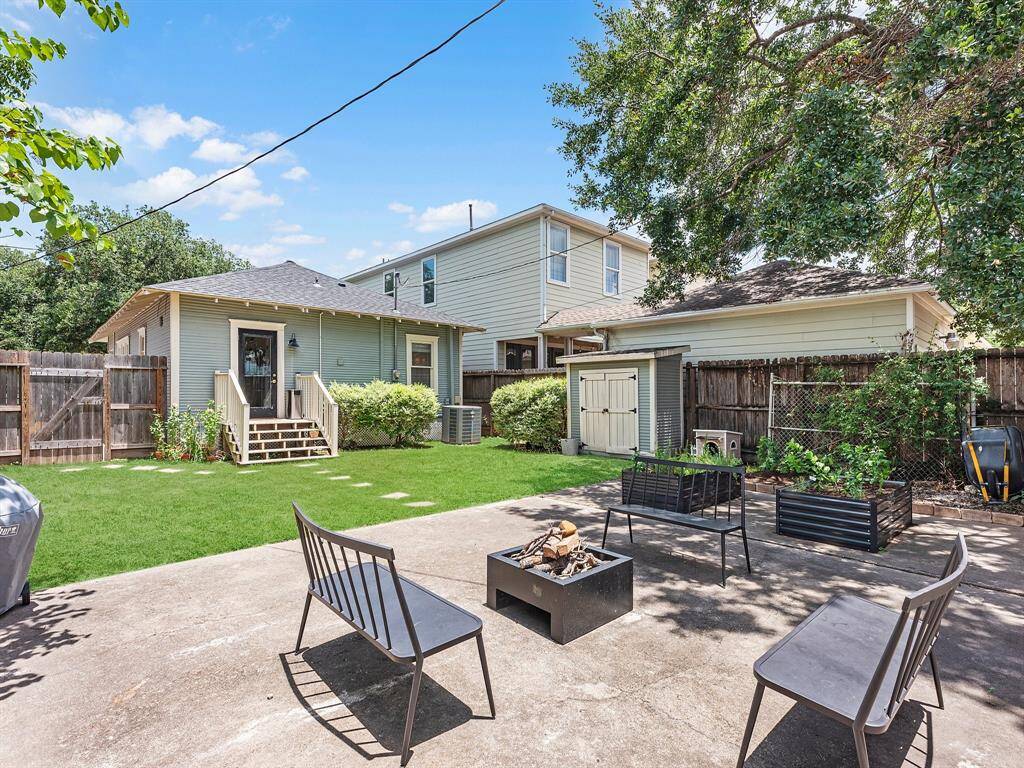 This fully fenced yard is ready for anything—whether it’s shooting hoops, gathering by the fire pit, tending a garden, or simply enjoying the low-maintenance green space.