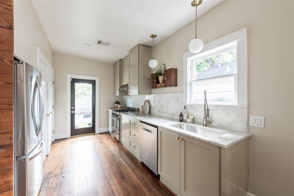 Vintage charm meets modern elegance in this recently renovated kitchen, where classic materials like Carrera marble and brass fixtures are paired with sleek appliances and thoughtful design.