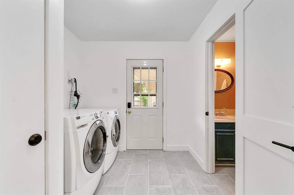 Functional laundry room featuring easy-to-maintain tile flooring and space for full-size appliances.