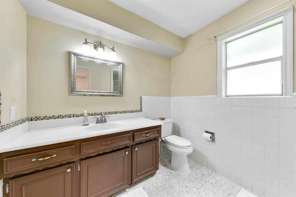 Primary bathroom features a single sink vanity with plenty of counter space and storage, offering ample room for daily routines and organization.