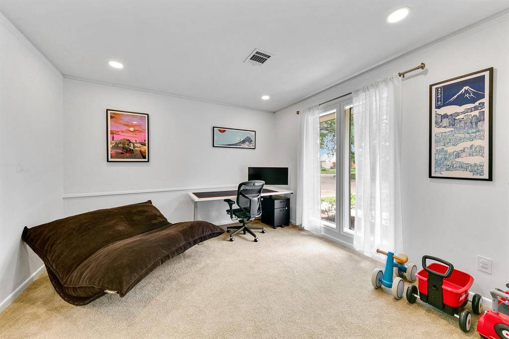 Bright and versatile room featuring a large window, providing ample natural light.