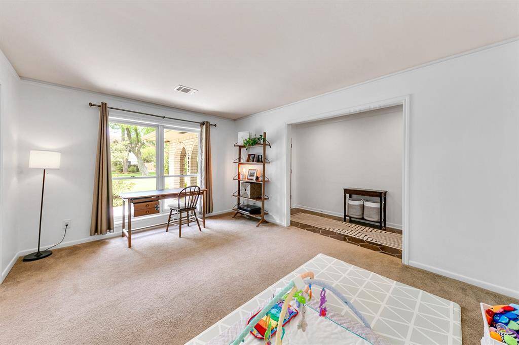 Bright and inviting room with large windows overlooking greenery.