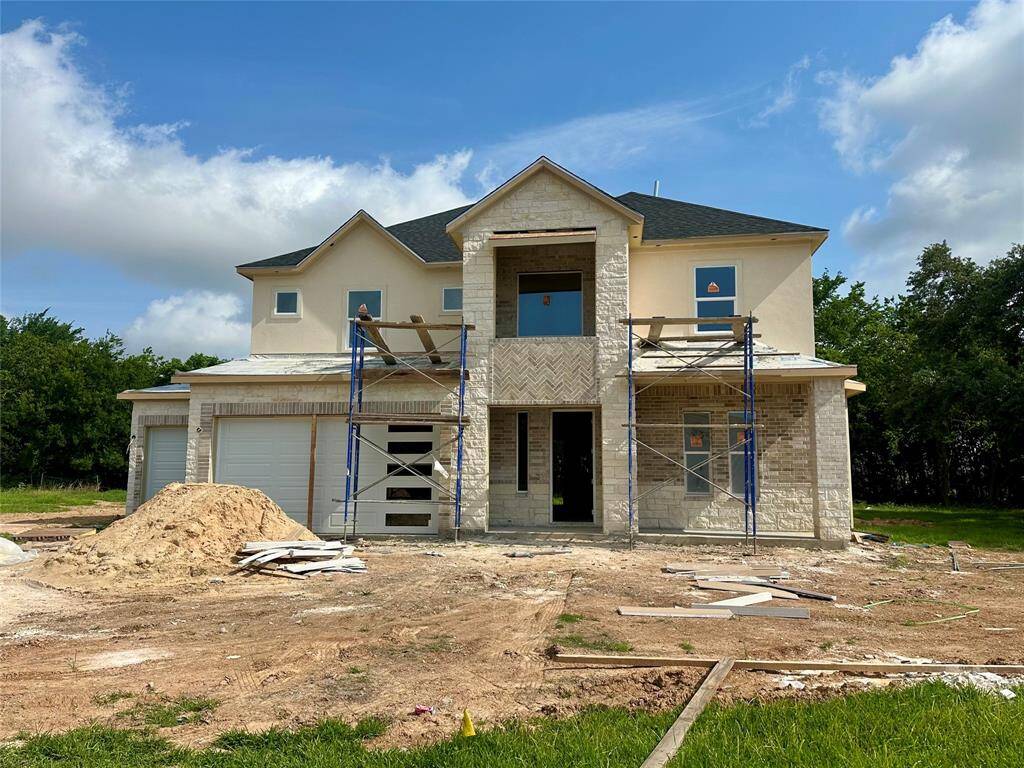 Current stage of the home as of 5/19/25. Lovely stone, brick and stucco front elevation with durable and stylish metal roof accents for maximum curb appeal!