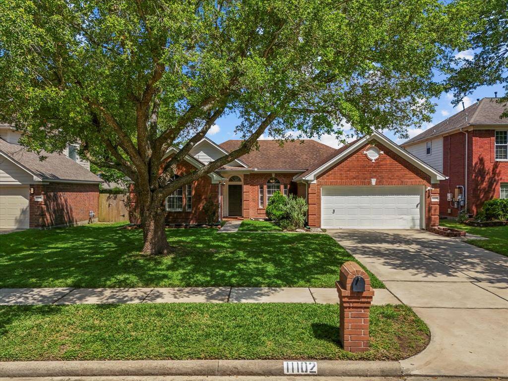 This charming brick home features a well-maintained front yard with a large tree providing shade. Adorable brick mailbox boosts the curb appeal.