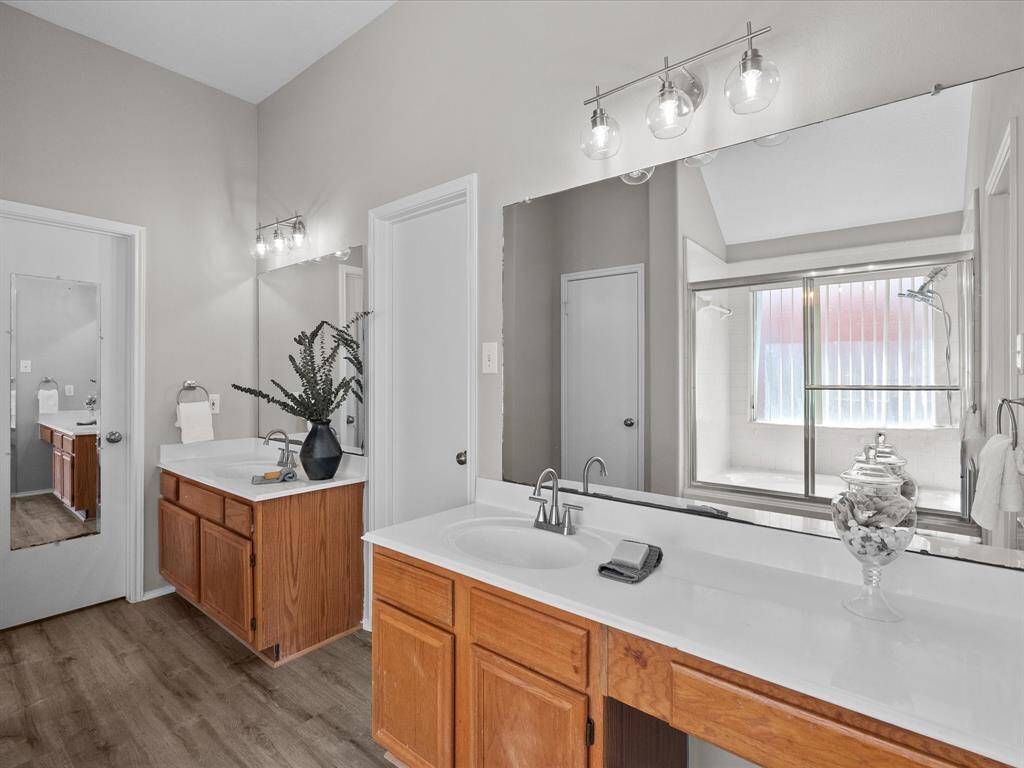 Attractive primary bathroom has double sinks and an expansive vanity.