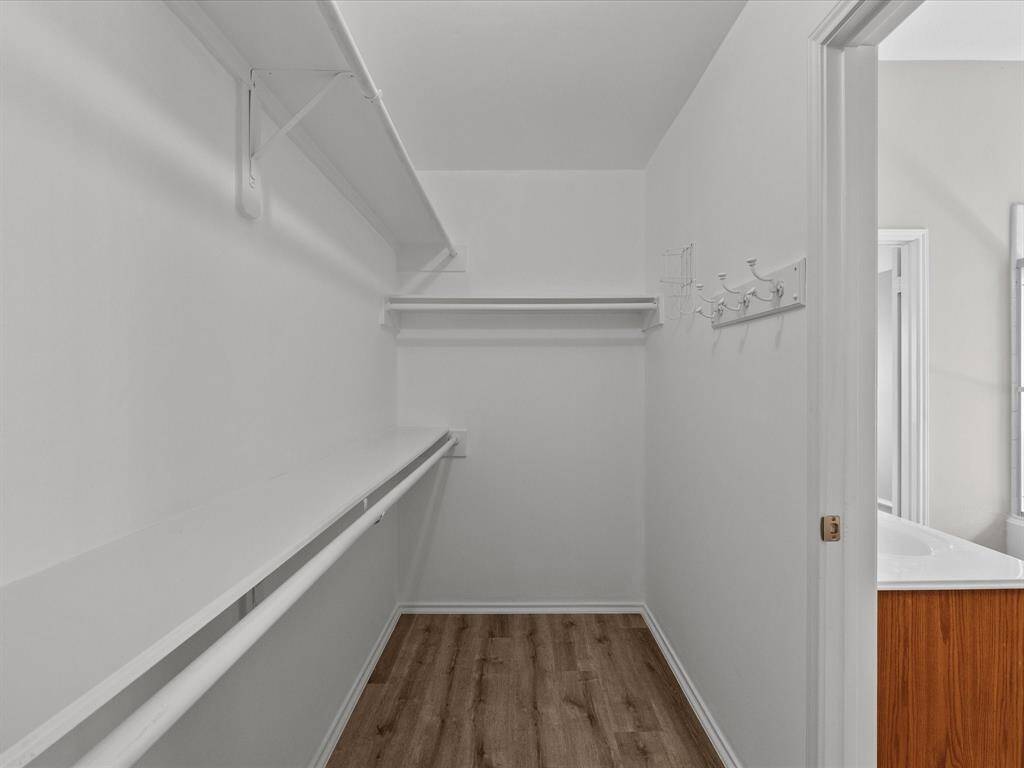 Spacious walk-in closet conveniently located in the primary bathroom.