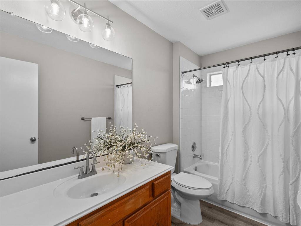Second bathroom is bright with a transom window over the shower/tub.