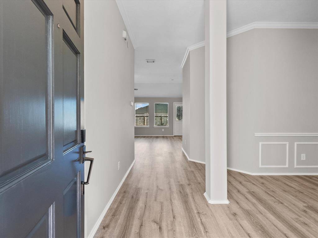 Enter this home into a bright, spacious entryway with wood-look LVT flooring and neutral walls.