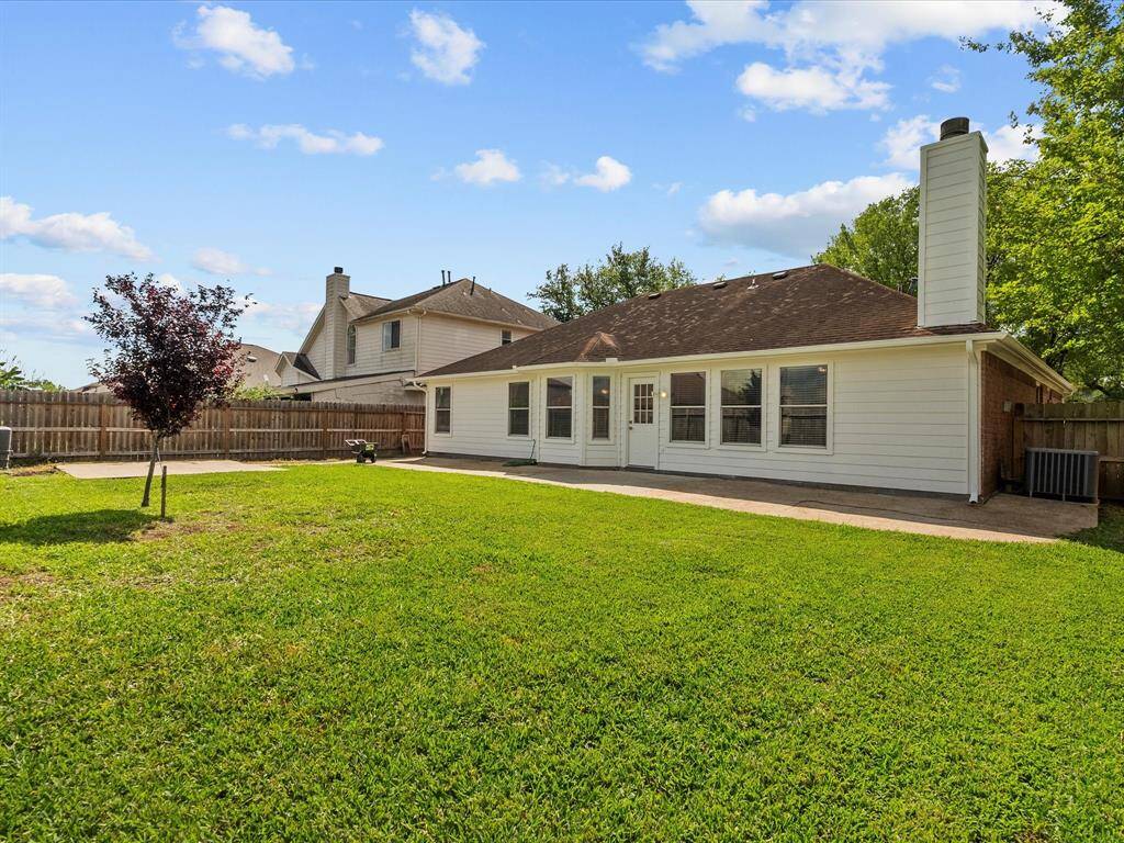 The house features a white exterior with multiple windows.