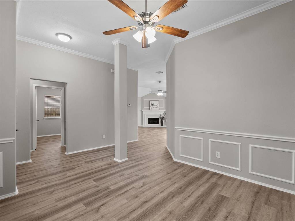This versatile space is perfect for a cozy sitting area or a home office, with secondary bedrooms conveniently located to the left of the entry.