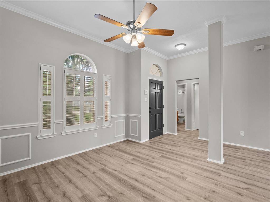 Features a large arched window with shutters, offering plenty of natural light.