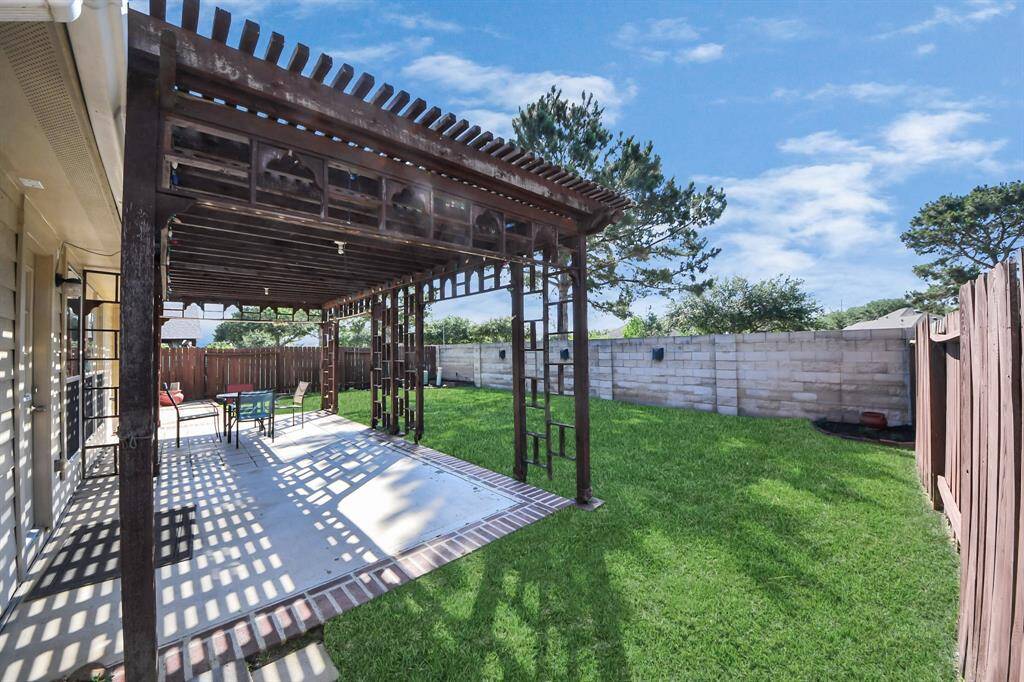 Enjoy this covered pergola with extended patio and NO back neighbors!