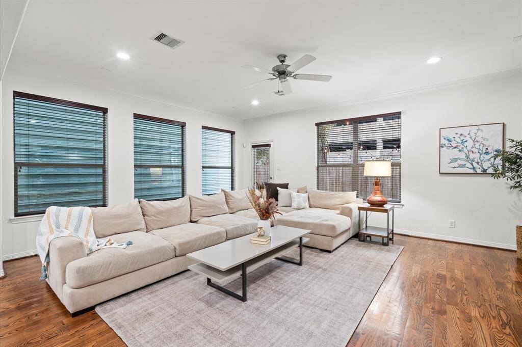 The Living Room You’ve Been Looking For. The heart of the home! Tall windows, gorgeous hardwood floors, a ceiling fan to keep things breezy—this is where Netflix marathons, Sunday naps, and deep convos with loved ones happen.