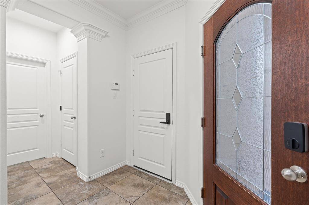 A Warm Welcome, Every Time. The moment you walk in, this home wraps you in comfort. A glass-paneled front door, elegant crown molding, and a coat closet ready to keep things neat—because first impressions matter.