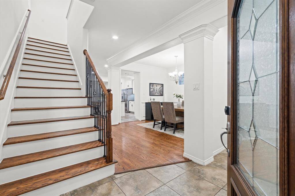 Step Inside – Where Style Meets Comfort. From the moment you walk in, you’ll feel it—the inviting energy of a home designed for effortless living. Rich wood floors, crown molding, and that gorgeous staircase set the stage for everyday elegance.