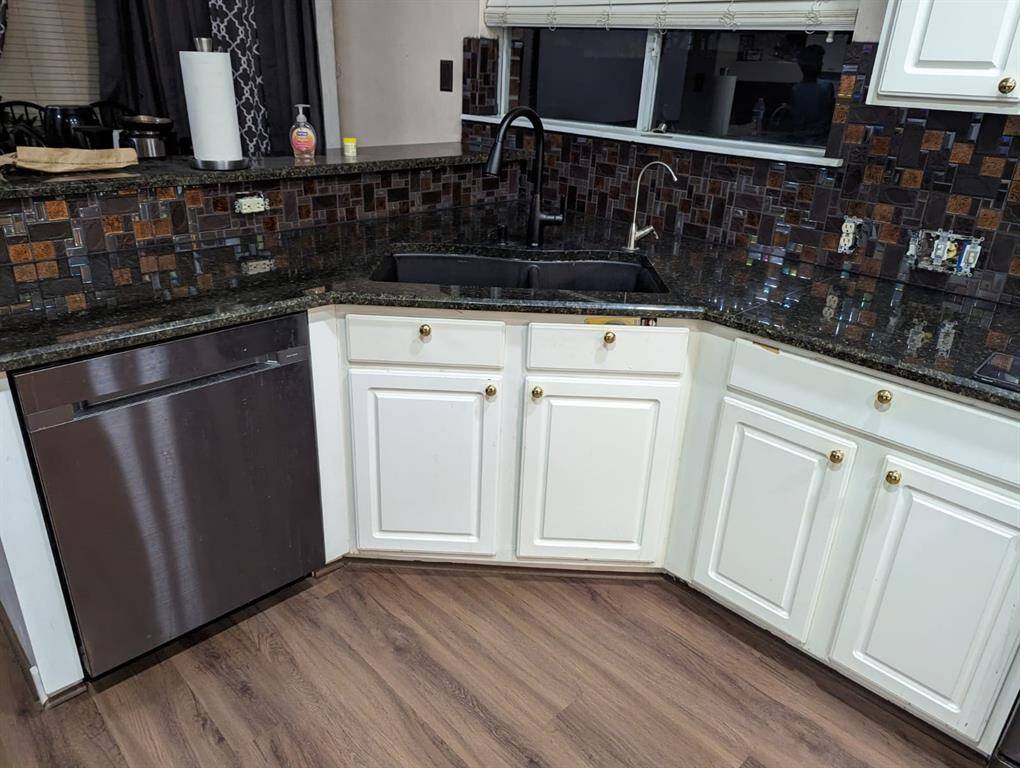 kitchen with vinyl floors and white cabinets