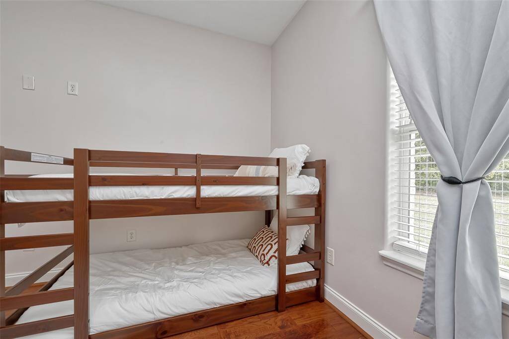 Bright & Airy Bunk Space – Natural light and soft colors create a playful yet relaxing vibe in this bunk room corner.