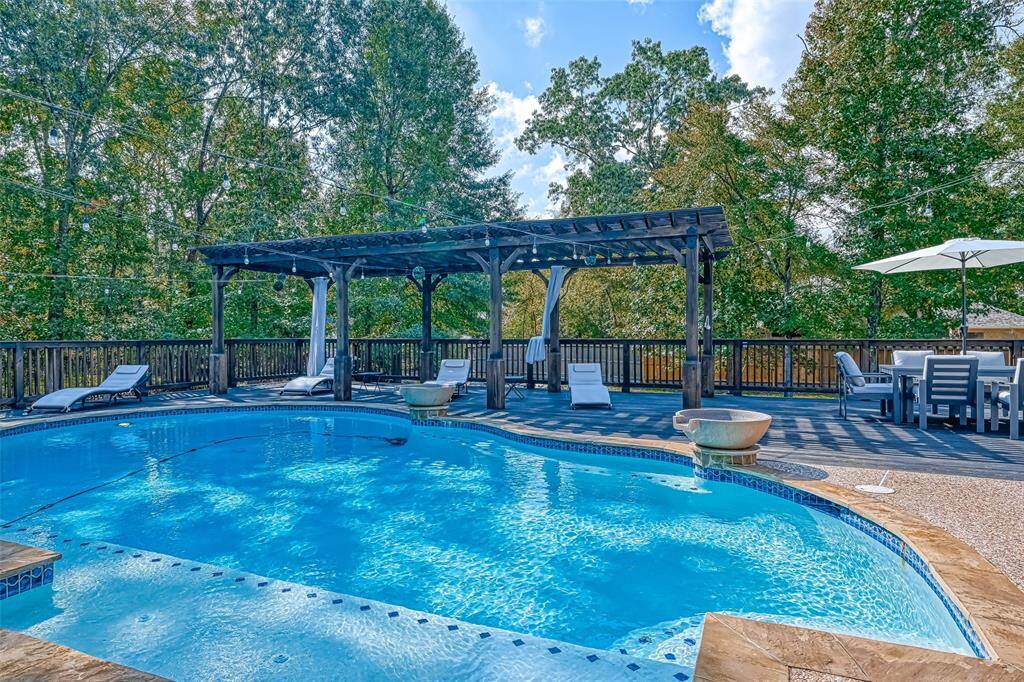 Sparkling Pool Retreat- Dive into the crystal-clear pool or unwind on the expansive deck surrounded by peaceful greenery.