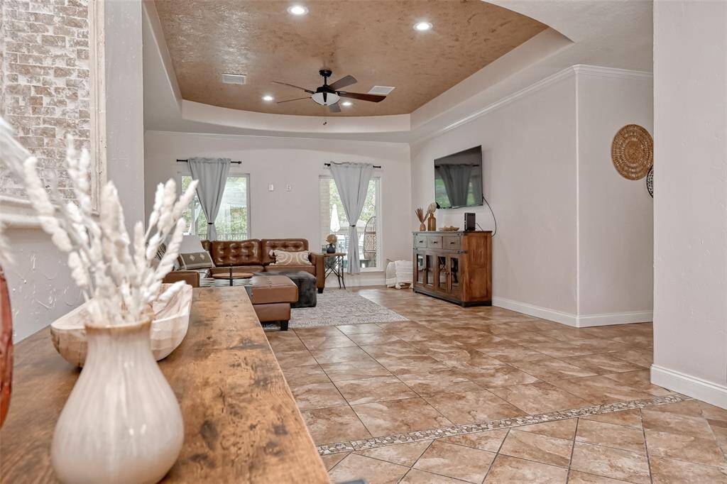 Seamless flow into the living area with views of the backyard, neutral tones, and elegant trim work give the space a bright and airy feel.