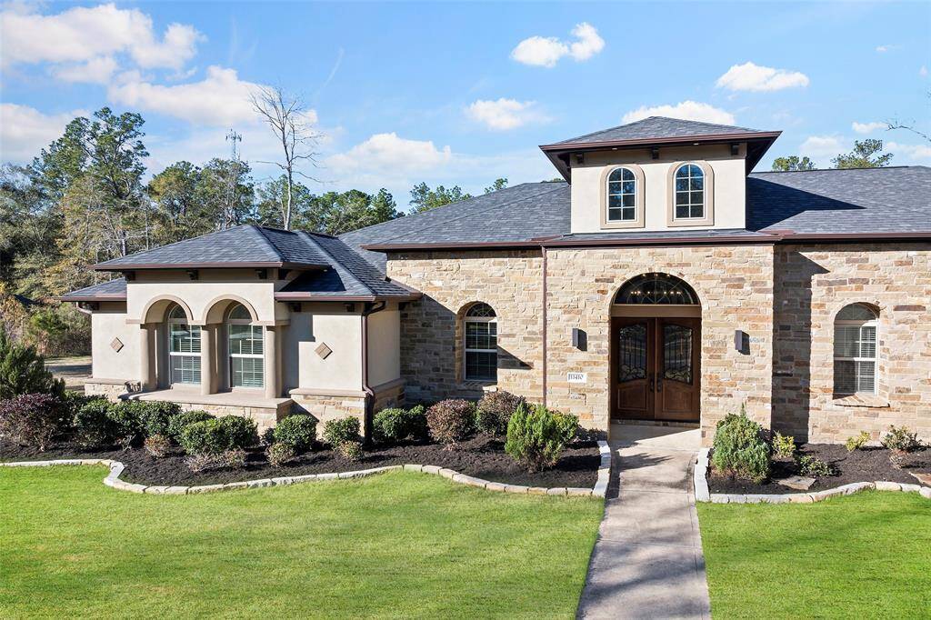 Exquisite 1-story, split floor plan 4-bedroom, 4 ½-bath home with an attached 3-car garage and circle driveway on a 1.7-acre lot in the gated community of Woodforest Estates. Designed for luxury and comfort, the entryway features stained concrete floors with a Texas Star design, leading to an executive office with custom cabinets and a view of the dining room.