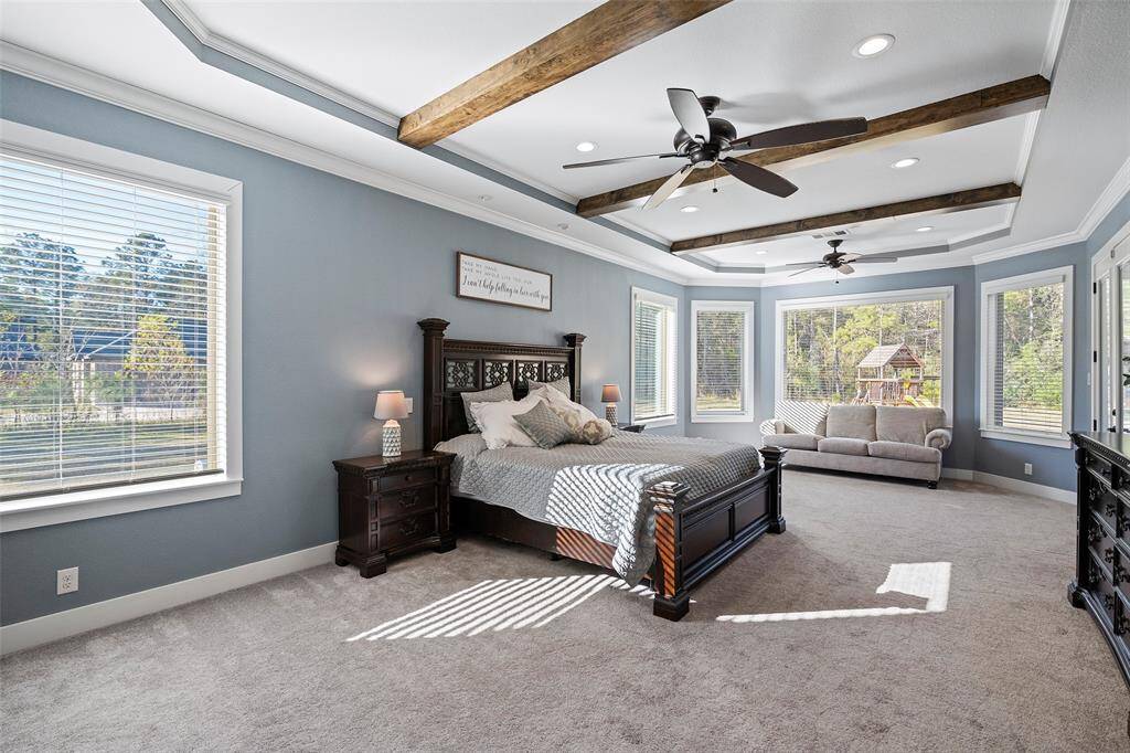 The spacious primary has a sitting area with an amazing ensuite bath & his & her closets.