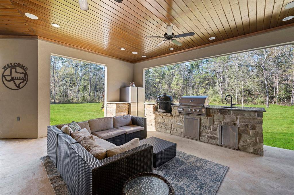 Enjoy entertaining on the Texas Patio with outdoor kitchen, wood ceiling, & recessed lighting.