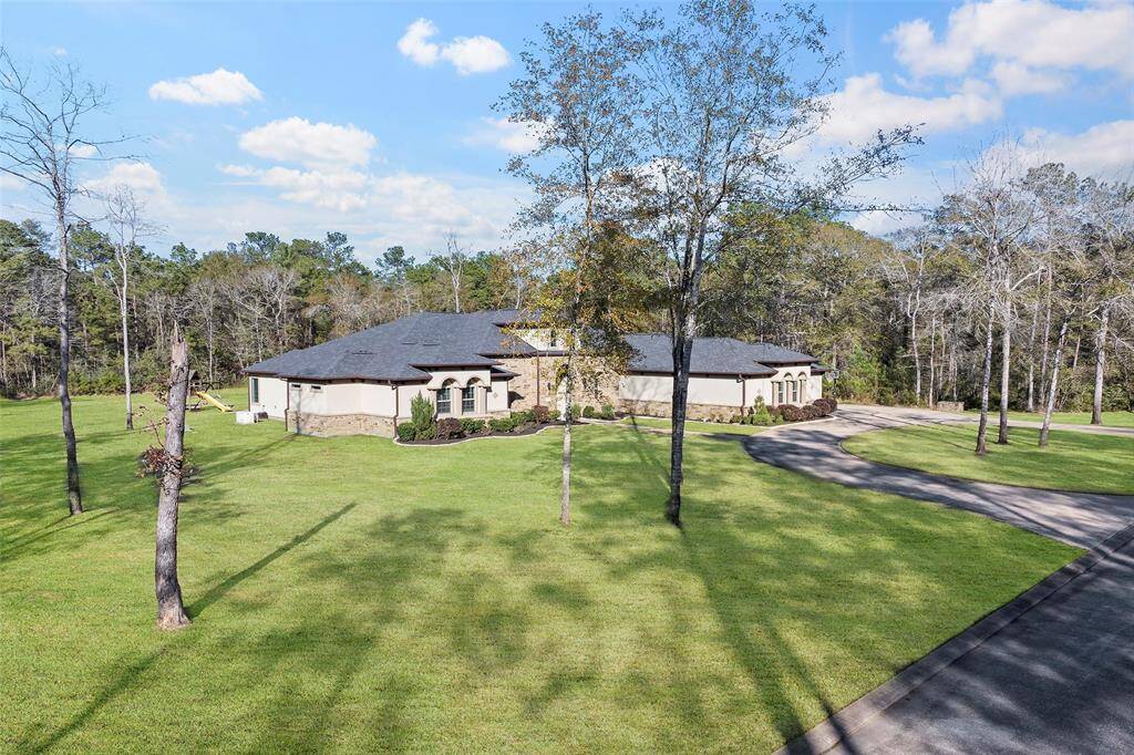 Secondary bedrooms have ensuite baths and walk-in closets, while the primary suite offers a sitting area, spa-like bath, and his-and-hers closets. Additional amenities include a craft room, MUD space, oversized laundry with sink, and a Texas patio with an outdoor kitchen. Convenient to Texas 249, FM1488, and the Woodlands Parkway. Shopping and entertainment close by in Tomball, The Woodlands, and Magnolia. Magnolia ISD.