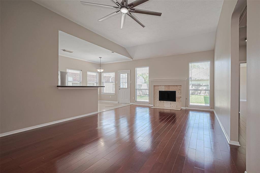 Family Room offering wood floors, fireplace, open to kitchen and views of the backyard