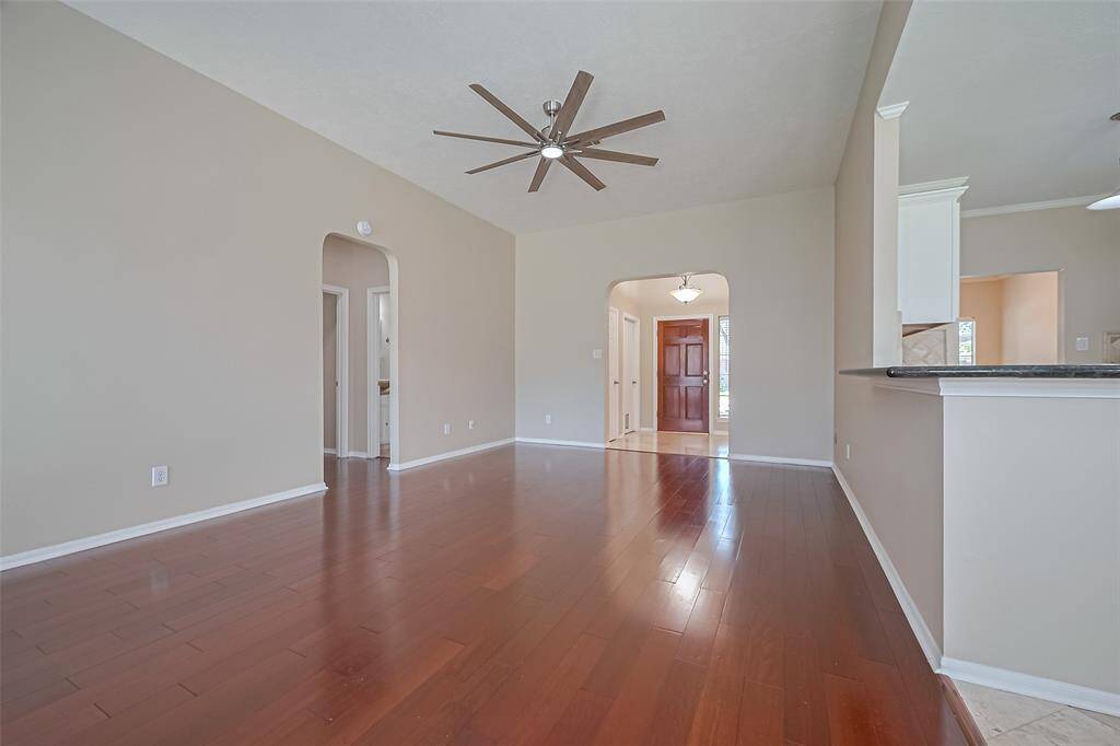 Family Room view facing the front door, beautiful wood floors, open to your kitchen area, door to the left goes to bedrooms