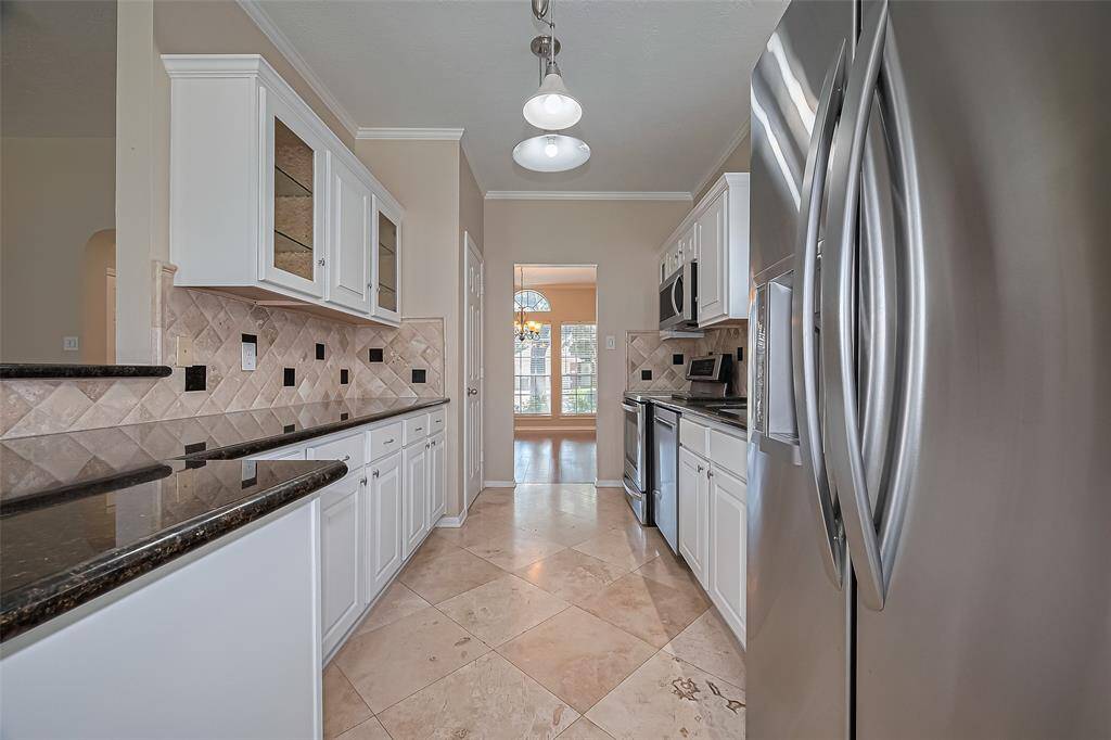 Beautiful travertine flooring, lots of counter and cabinet space