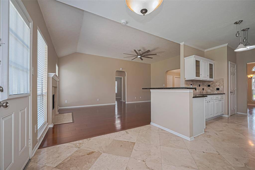 View from Breakfast room into family room, door to the left leads to your well maintained backyard