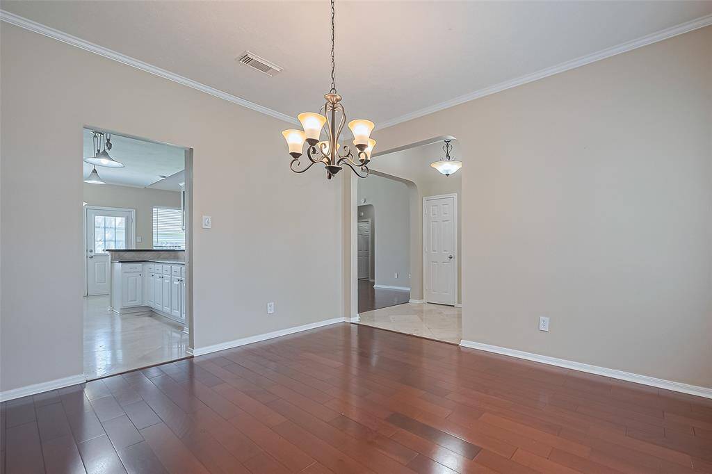 Another view of the formal dining area, opens to kitchen and front entry