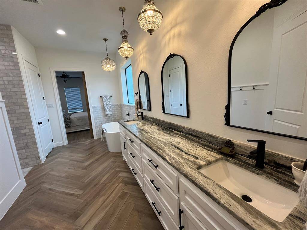 Leathered quartzite counters, upgraded lighting, and site built cabinets with lots of storage