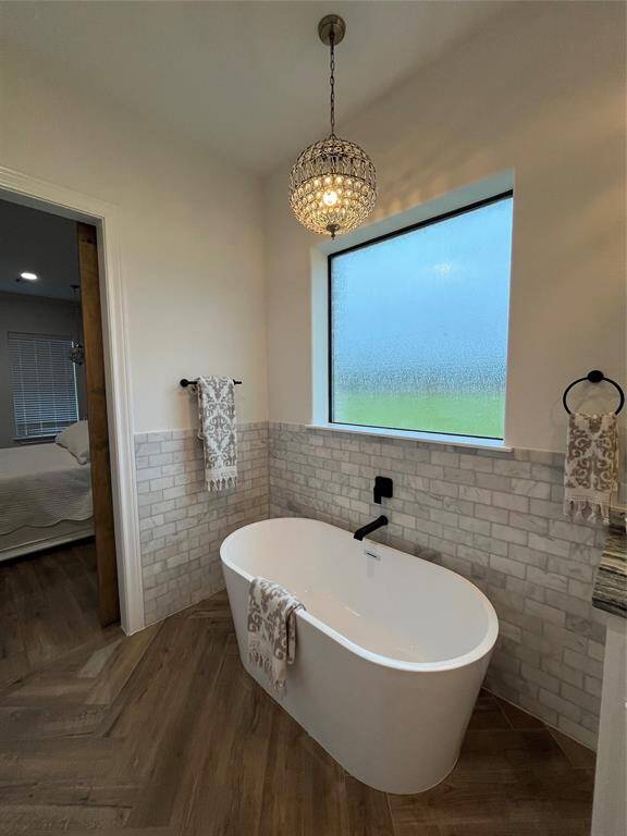 Freestanding tub with marble backsplash