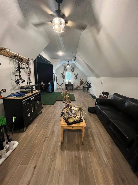This room is currently being used as a "mancave" but could be a bedroom. It has an ensuite bath and windows behind the golf simulator.