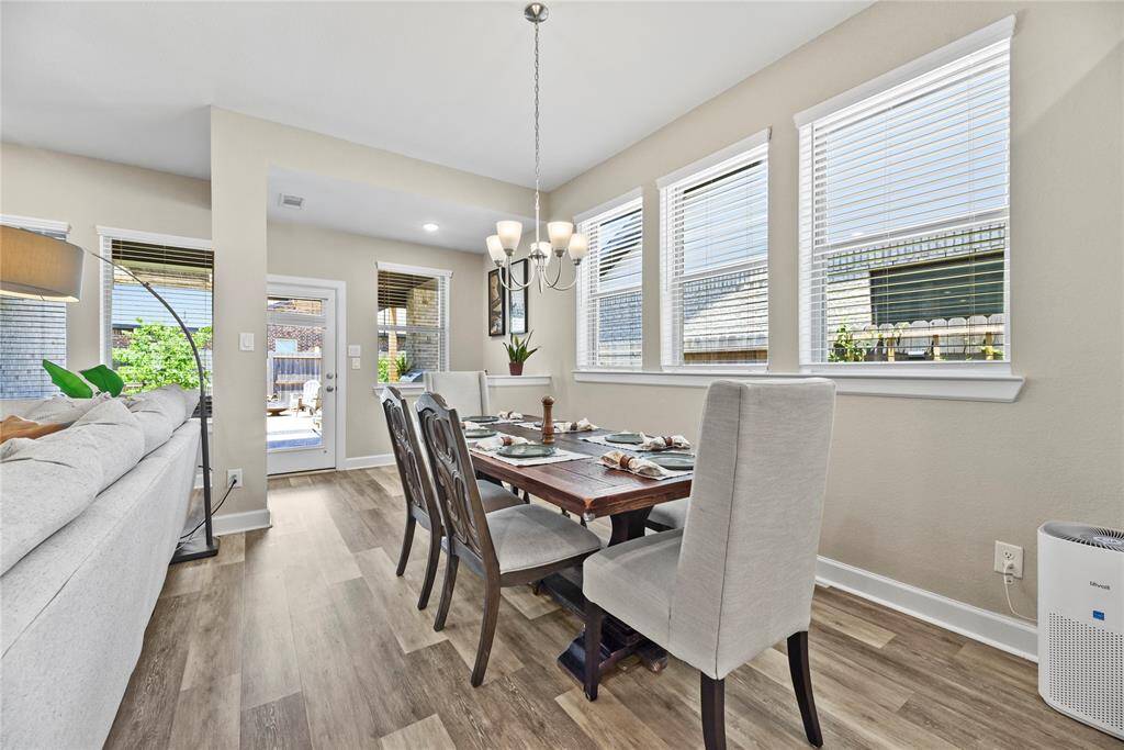 This inviting dining area features plenty of natural light from multiple windows, and easy access to the outdoor patio. The open layout flows seamlessly into the adjacent living space and will actually be a well used space.