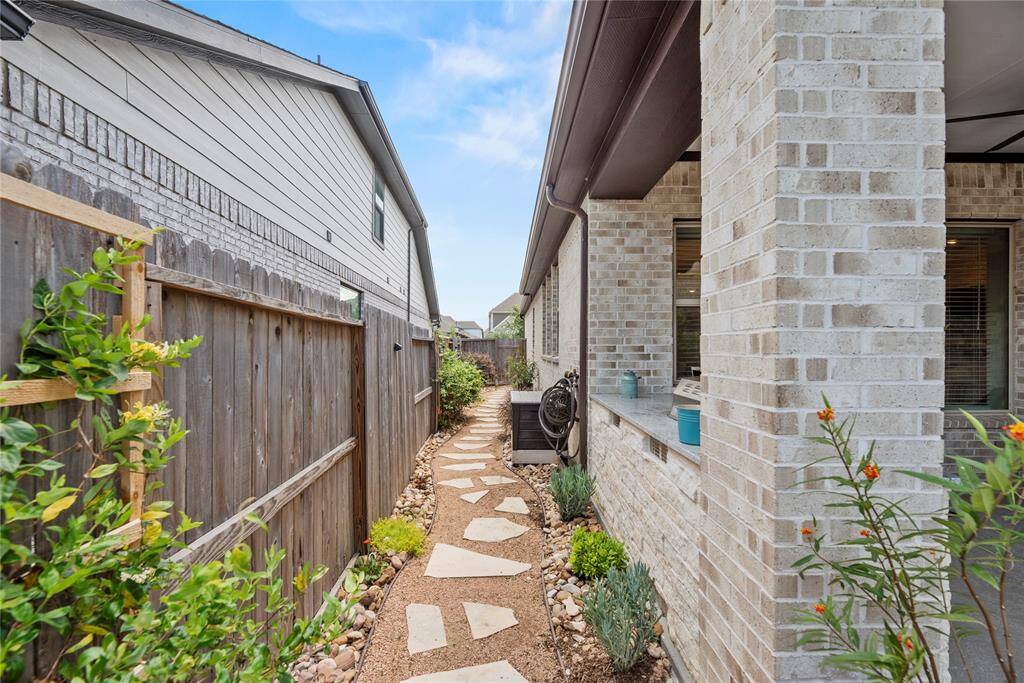 What a perfectly finished out path along the home that makes you feel like you are in your very own oasis!