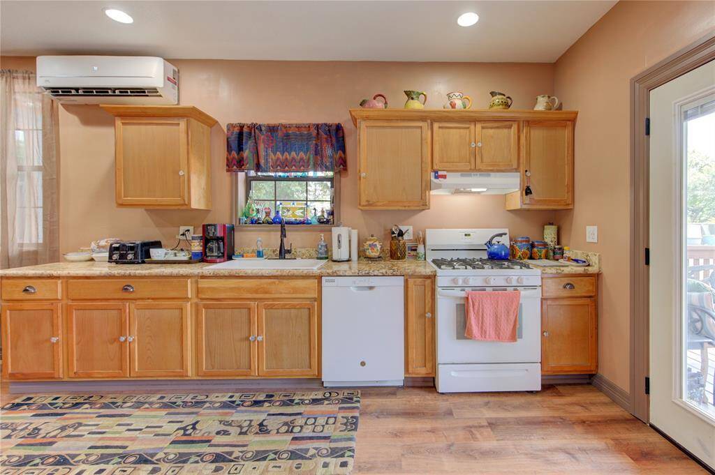 Another view of kitchen and window overlooking driveway