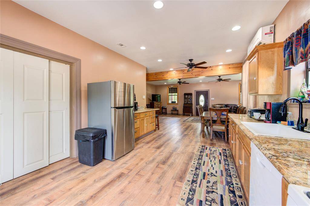 Laundry room next to refrigerator. Washer & dryer can stay