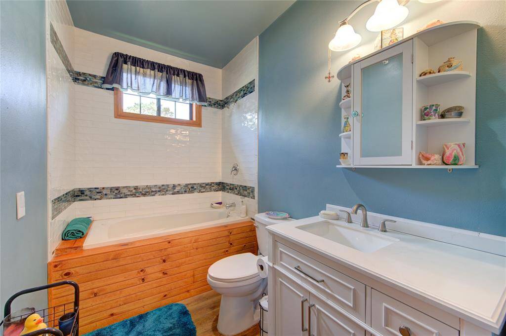 1st floor bathroom with a jetted tub and shower.