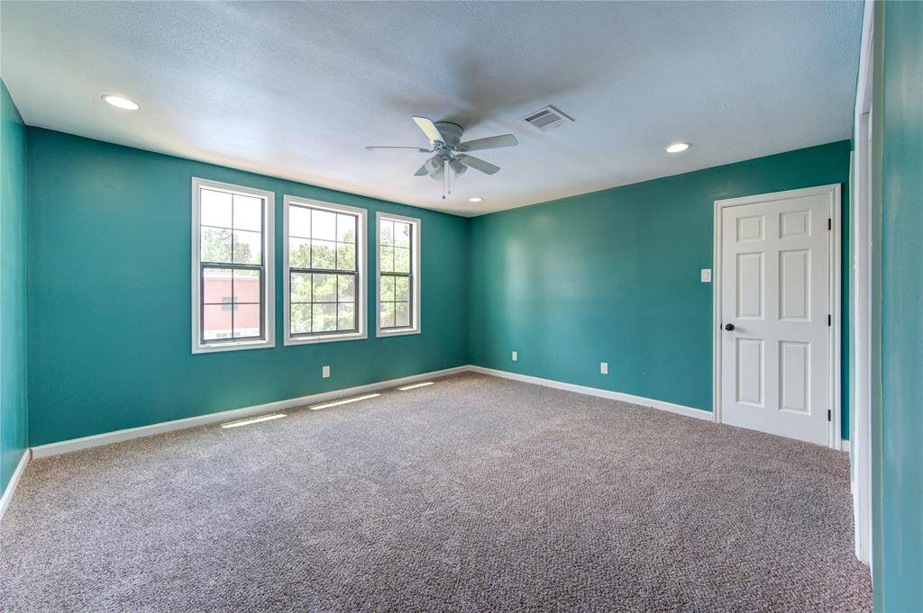 This spacious bedroom overlooks the pool