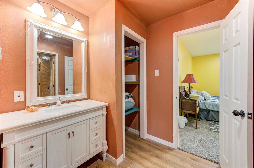 Bathroom vanity & linen closet located  between bedrooms & has access from hallway