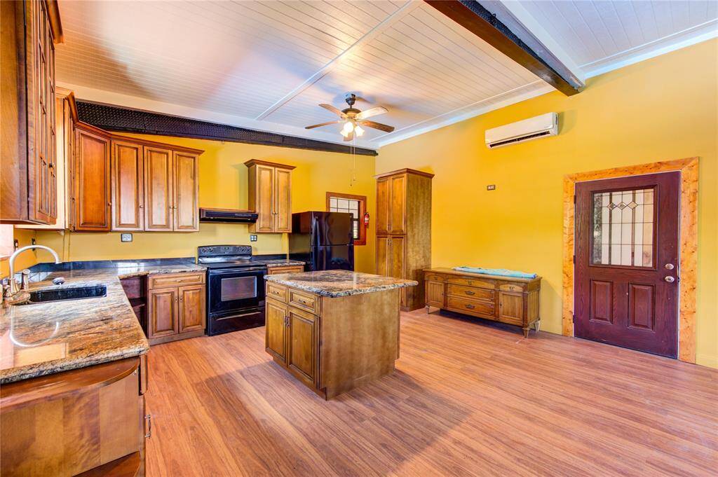 Apartment entry door into a lovely island kitchen.