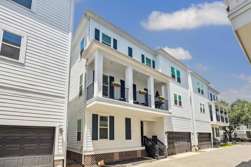 Fabulous townhouse with a sleek white exterior and black shutters built in 2019. It features a nice  balcony and a welcoming front porch. The home has a two-car garage and is nicely located in the middle of the community.