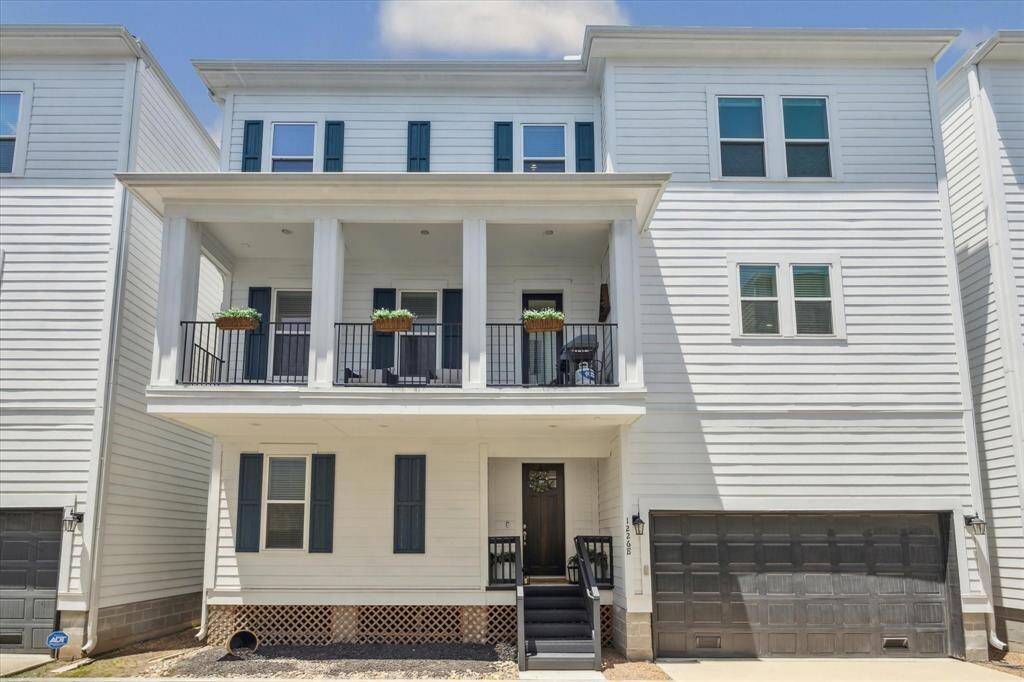 This photo shows this wonderful quiet gated residential community. It is surrounded by well-maintained landscaping. The entrance is secured with a black metal fence, offering privacy and security.
