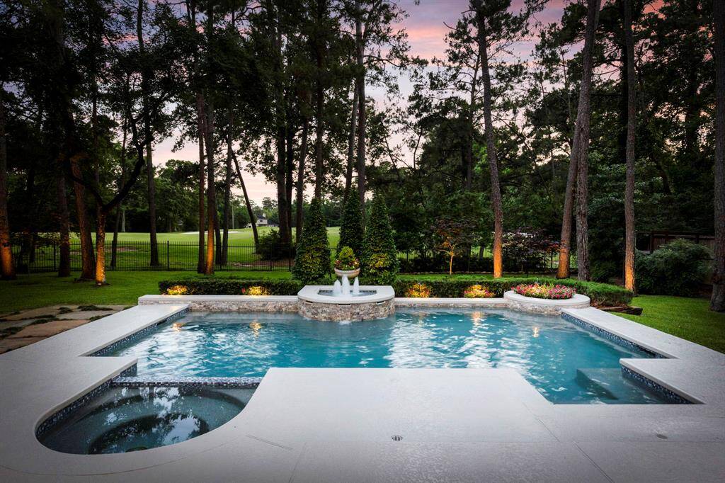 The backyard is a true resort-style sanctuary, featuring a completely updated pool and spa with a Pebble Sheen surface, stunning new tile and stonework, and a tranquil water feature.
